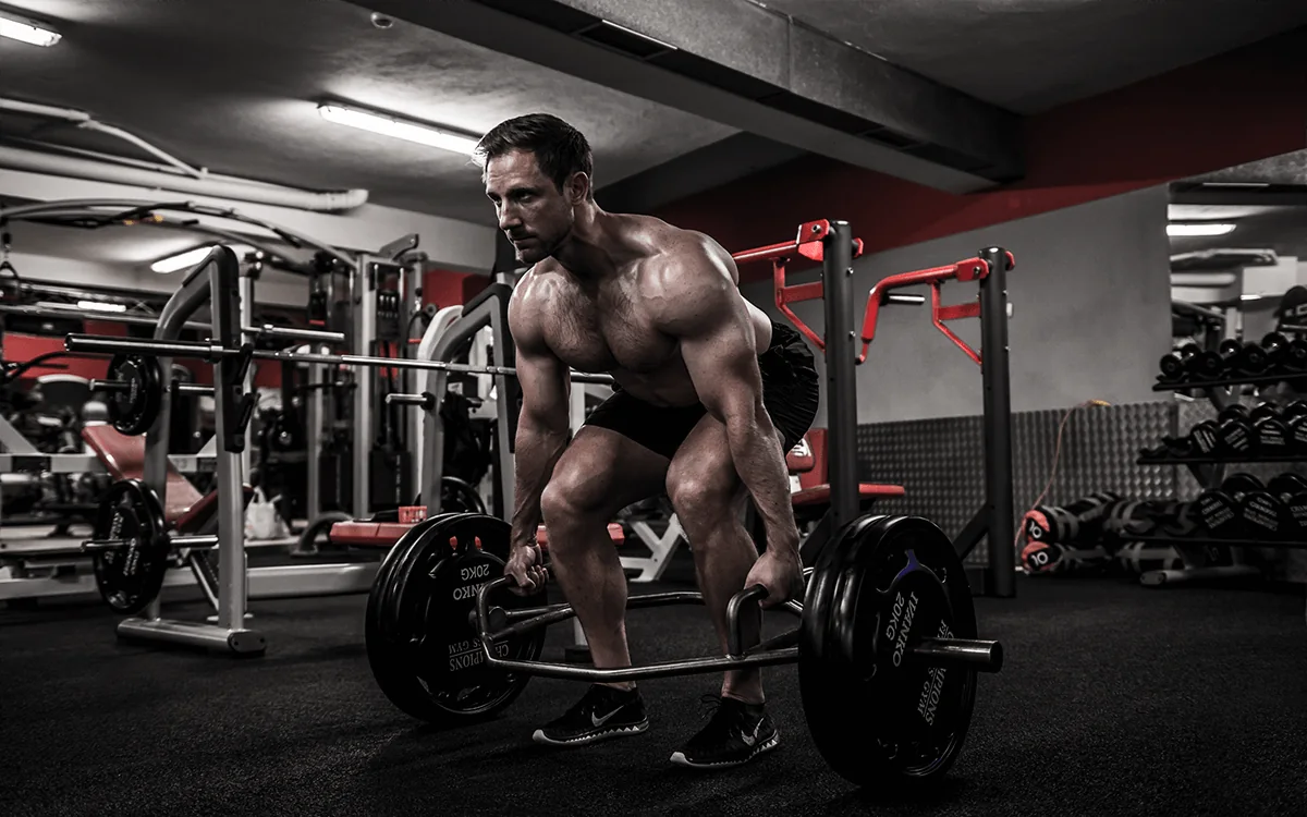 Jonny preparing a loaded trap-bar deadlift in the gym